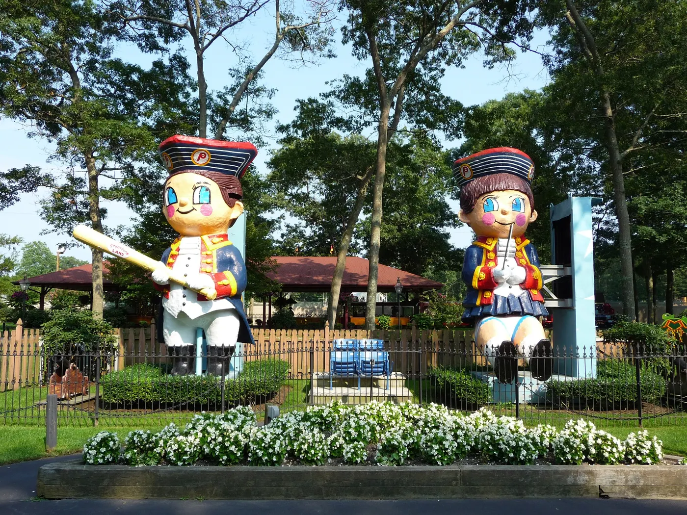 Two giant storybook characters in front of the Storybook Land castle