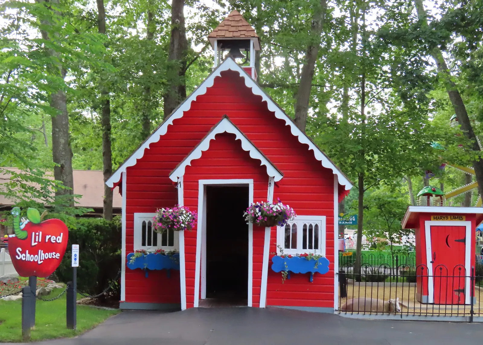 The red Little Red Schoolhouse with flower boxes at Storybook Land